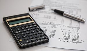 A calculator and some sums on a piece of paper